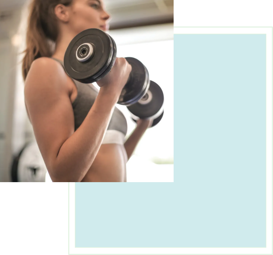 A woman is holding two black dumbbells in her hands.