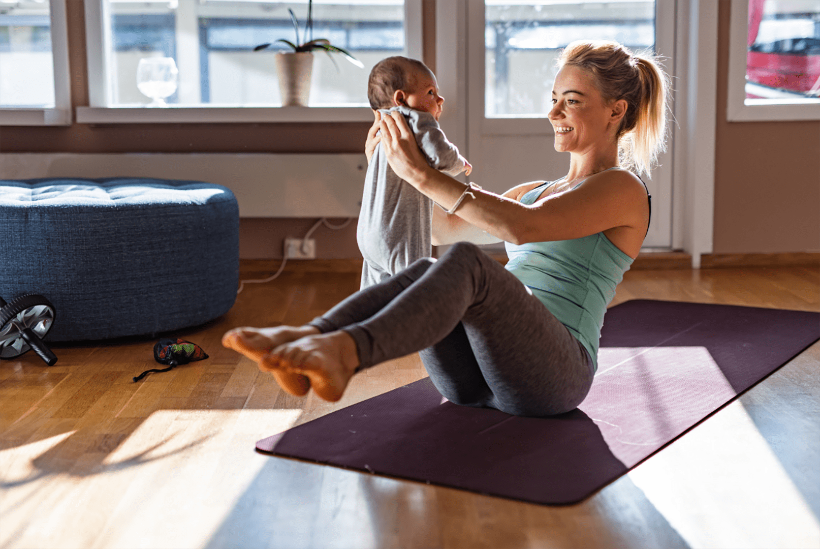 A woman is doing sit ups on the floor